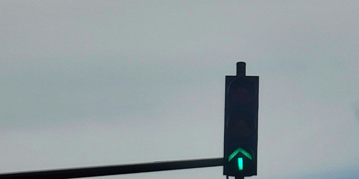 A traffic light with a green arrow pointing up.